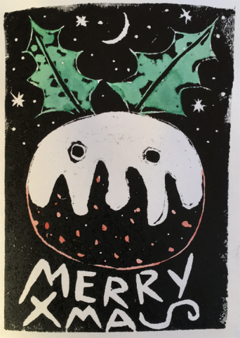 The image is a woodcut. It is on a black background with stars and a moon. The central image is a round Xmas pudding, with what could be custard dripping down. Below in bold handscript it says MERRY XMAS but the S of XMAS is lying down. The pudding has pink speckles below the custard. The custard has two round dots in it. They look like two eyes on a snowman, and there are two pieces of green holly sticking out at angles from the top of the pudding like ears. All in all it is a jolly Xmas pudding face.