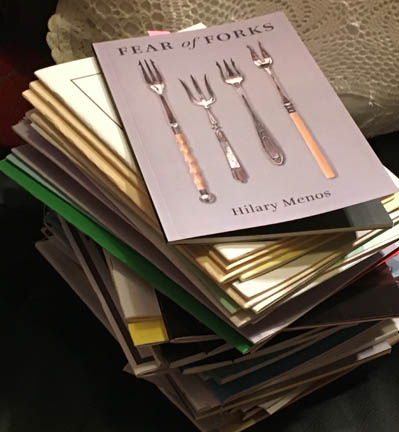 Photograph of a pile of pamphlets waiting to be reviewed